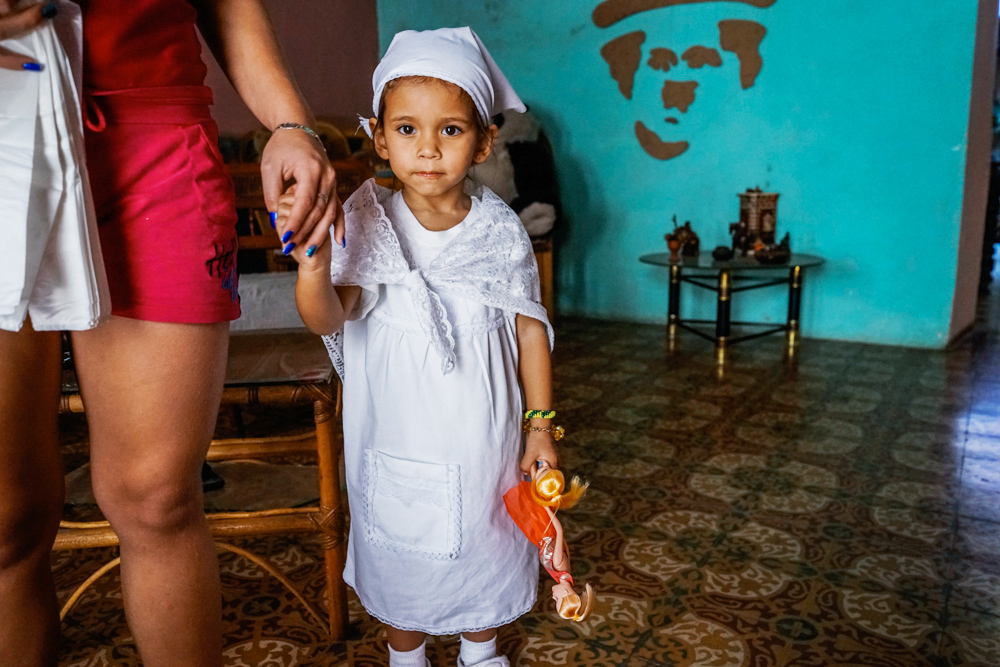 young cuban child holding doll