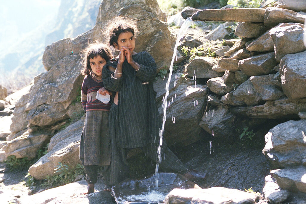 Young kashmiri girls near water stream