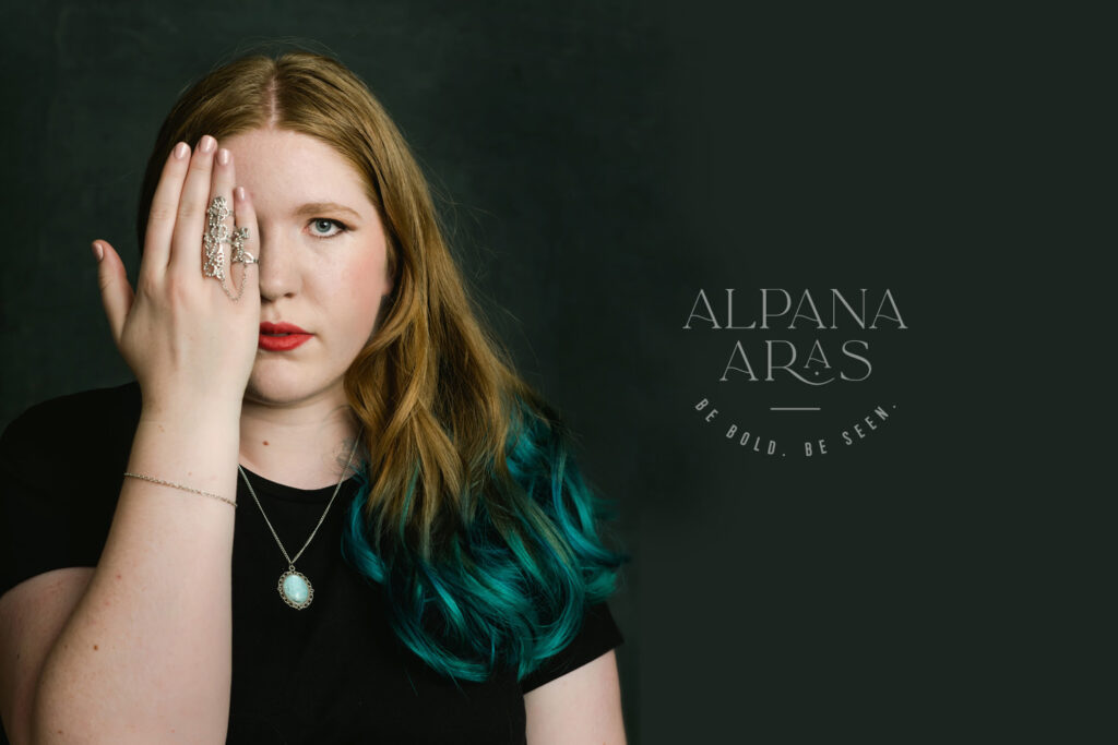 Headshot with bold hair and jewelry